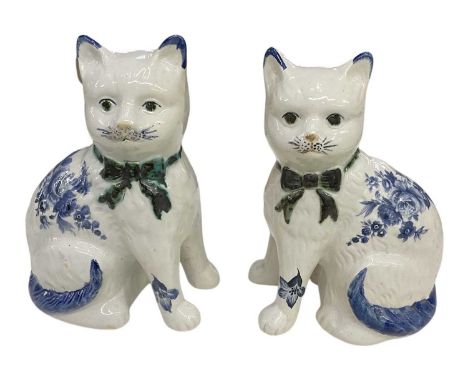 A pair of Reproduction Staffordshire ceramic blue and white floral decorated figures of cats, both height 19.5cm (2).