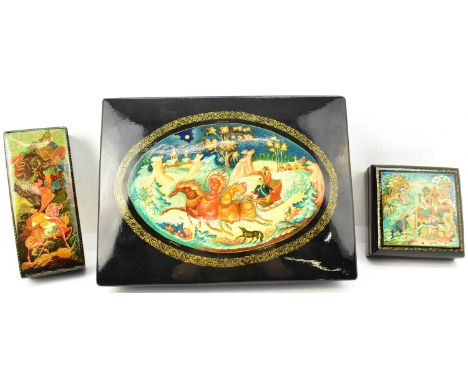 Three vintage Russian black lacquered boxes with red lacquered interiors, the largest showing folklore snow scene, 4.5 x 24.5