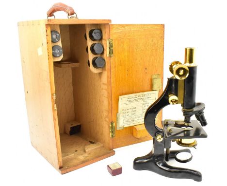 W WATSON & SONS LTD; a Kima student microscope with brass and black painted body, height 32cm, in wooden carry case, with var