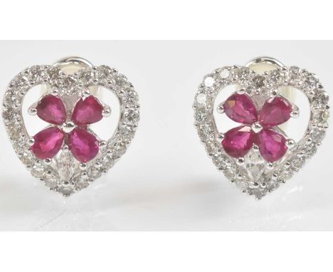 Standard VAT A pair of 18ct white gold diamond and ruby heart shaped ear studs, centred with four pear shaped rubies within a