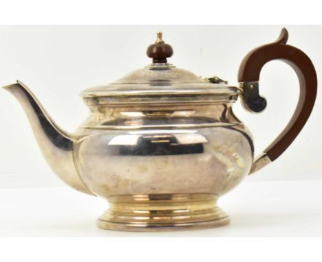 COOPER BROTHERS &amp; SONS LTD; an Elizabeth II hallmarked silver teapot of typical shape, with wooden finial to lid and wood