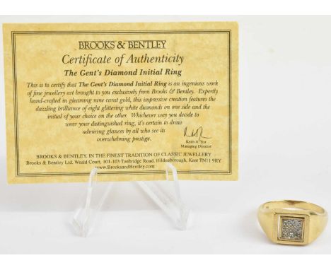 BROOKS &amp; BENTLEY; a 9ct gold diamond initial signet ring, the table rotating with one side bearing the initial 'R', the o