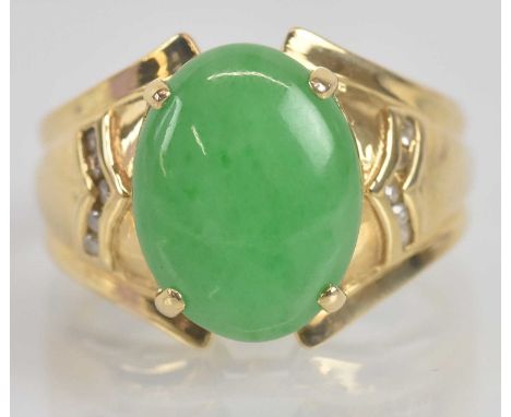 Standard VAT A 14ct yellow gold oval cabochon jade set ring with ten small round brilliant cut diamonds bezel set in angled p