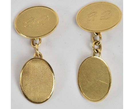A pair of 9ct yellow gold cufflinks with engine turned decoration, inscribed with initials 'BD', combined approx 8.4g.