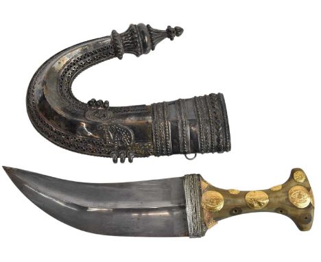 An Arabian Jambiya dagger, with white metal scabbard and handle set with four yellow metal coins, length 31cm, length of blad