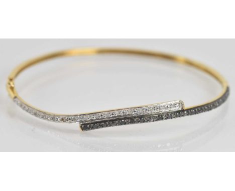Standard VAT A 9ct yellow gold diamond and black diamond double row bangle, internal width 57mm, approx 5g.PLEASE NOTE: VAT i