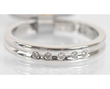 Standard VAT A 9ct white gold diamond set ring, the five round brilliant cut stones in rubover setting totalling 0.06ct, size