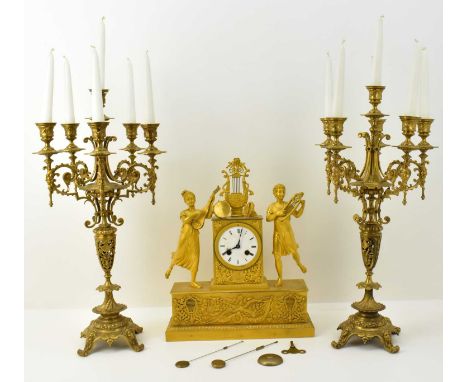 A 19th century gilt metal clock, the white enamel dial set with Roman numerals, with outer minute track, two wind holes and F