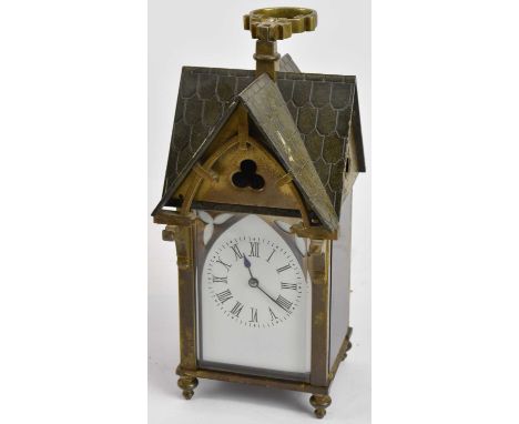 A late 19th century Gothic Aesthetic Movement brass cased carriage clock modelled as a house, with four section roof and carr