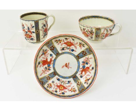 WORCESTER; a first period trio painted in the Imari palette with floral springs and gilt trellis pattern, comprising coffee c