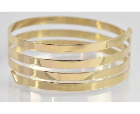 Standard VAT A 9ct yellow gold thin sprung bangle, approx 10.6g.PLEASE NOTE: VAT is payable on the hammer price of this lot. 