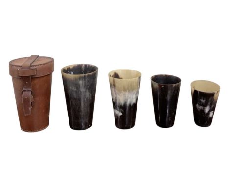 A graduated set of four horn hunting beakers, tallest height 12.5cm, diameter 8cm, in fitted leather case.