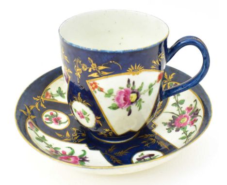 WORCESTER; a first period coffee can and saucer, with floral fan panels on a cobalt blue ground, the saucer with matching pat