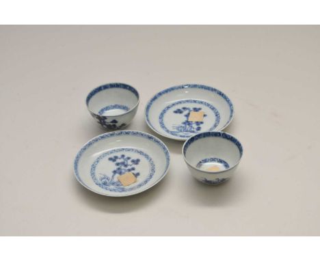 A pair of Nanking cargo miniature blue and white Chinese porcelain tea bowls and saucers, the bowls measuring 3.5cm high, 6cm