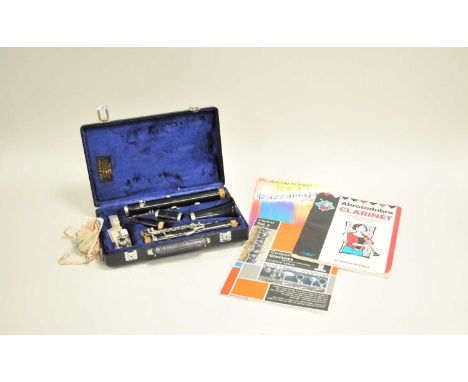 A cased Buffet Crampon clarinet, numbered 429634, together with student's learning guides.