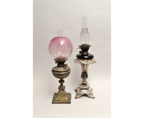 A Victorian electroplated lamp stand, accommodating a ruby glass oil lamp, with clear glass chimney, the stand 36cm high, 69c