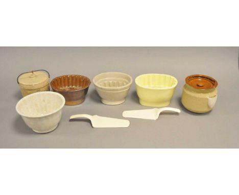 Four English earthenware jelly moulds including a brown salt-glazed 'Rose' and a Bristol pale yellow 'Rose' examples, a 'Chal