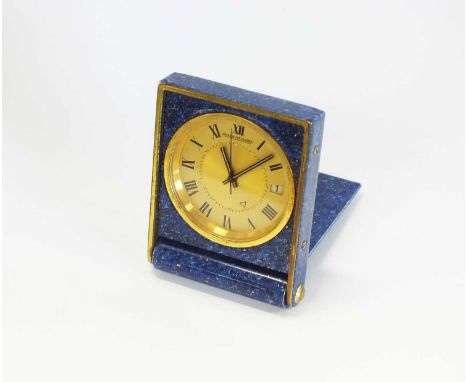 A Jaeger Le Coultre Memovox travel clock, the gilt dial with black Roman numerals, within lapis lazuli effect case