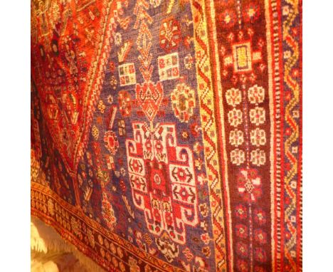 A fine south west Persian Qashgai carpet 257 x 160cm, central diamond medallion with repeating petal motifs on a terracotta f