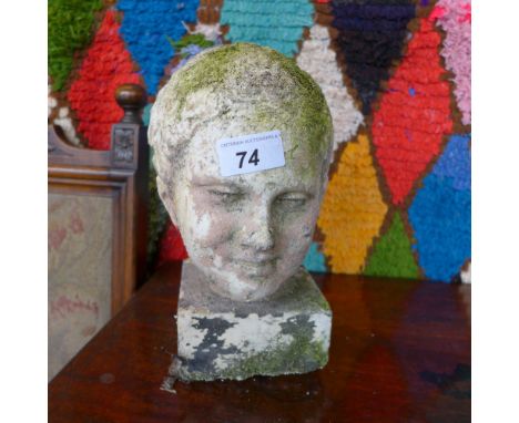 A stone portrait bust of a boy on a square base, cast from a bust at the British Museum 