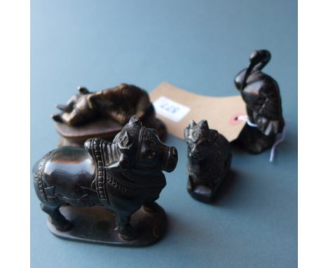 A collection of Indian black stone figures of Nandi, Ibis and another, with a similar brass item 