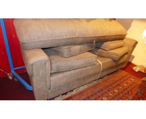 A 1970's sofa bed upholstered in green fabric 