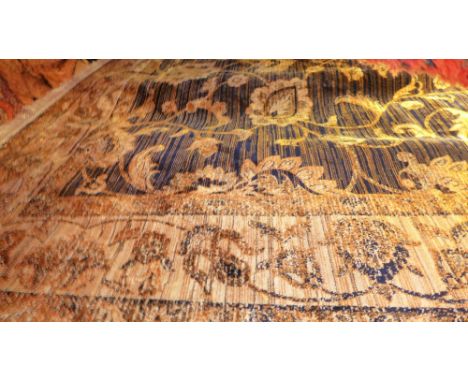 A Ziegler style carpet decorated with palmette designs on a midnight blue field surrounded by a frieze border 280 x 200cm 