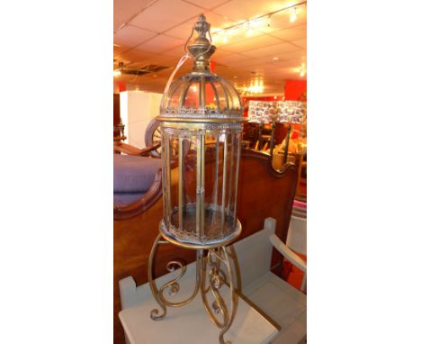 A brass and glass dome form storm lantern on stand