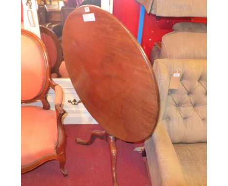 An 18th century mahogany tilt top table, the circular top over a turned stem raised on tripod supports 