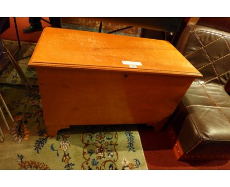 A cedar wood trunk raised on shaped bracket supports 