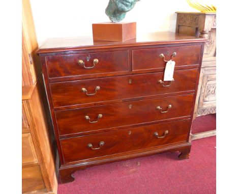 A George III mahogany chest of two short and three long graduated drawers, raised on bracket supports 