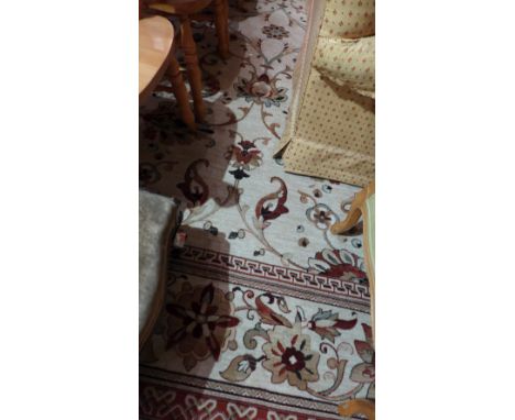 A large Persian style carpet with floral design on beige ground 