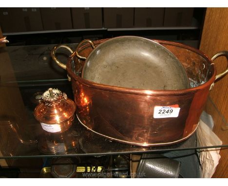 Two copper pans and a small oil lamp base.