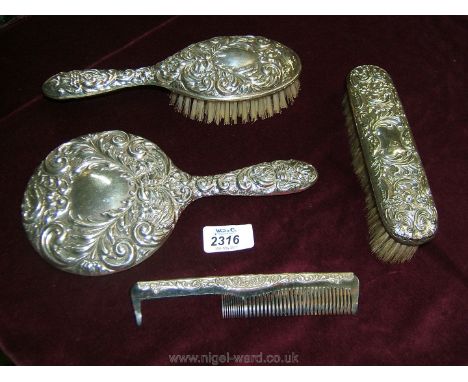 A Silver backed hand Mirror, brushes and comb