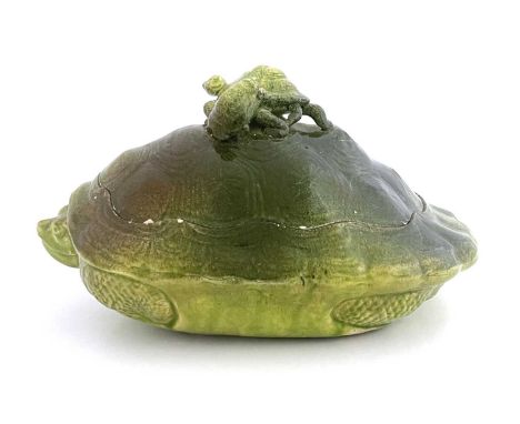 An art pottery turtle soup tureen, circa 1880, green faience glazed earthenware, modelled as a turtle with two terrapins on i