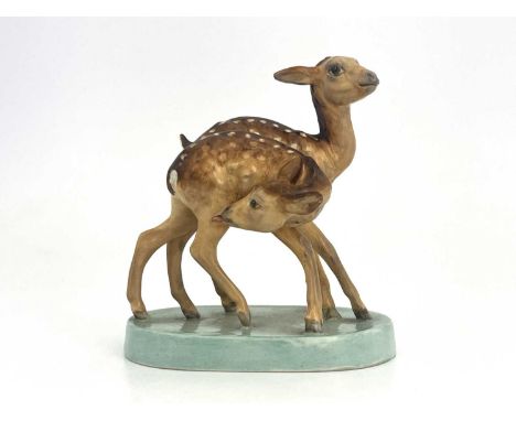 Doris Lindner for Royal Worcester, Young Spotted Deer, modelled as two fawns on oval celadon glazed base, shape No.3316, 13cm
