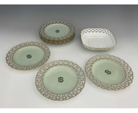 A set of eight Minton dessert plates, circa 1877, circular form decorated with a monogram to a sage green ground, within reti