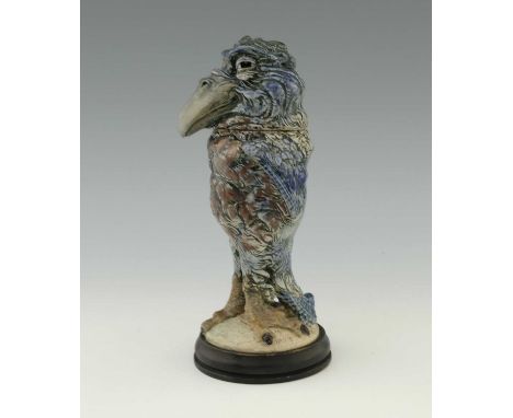 Robert Wallace Martin for Martin Brothers, a stoneware characterful sculptural bird jar and cover, 1909, modelled with a broa