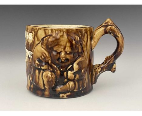 A Rockingham Ware Bennett Pottery Baltimore style shaving mug, circa 1881, cylindrical form, decorated with relief moulded se