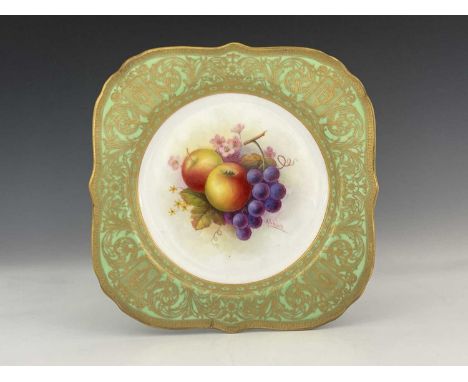 A. Shuck for Royal Worcester, a fruit painted cabinet plate, gilt scroll and green border, puce mark, 21cm wide