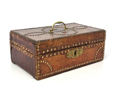 A George III tan leather bound and metal studded correspondence casket, gilt metal swing handle and scroll escutcheon, paper-