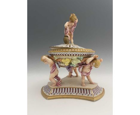 A Royal Worcester centrepiece, circa 1866, modelled as three cherbus bearing a covered bowl with grape and vine relief moulde