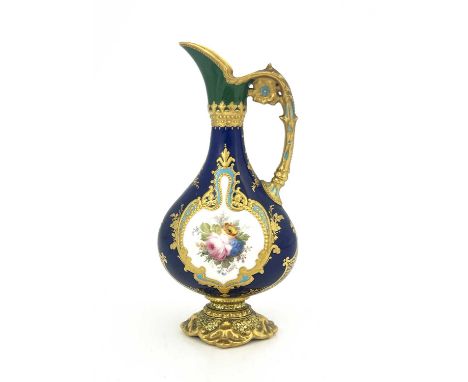 Leroy for Royal Crown Derby, a Kedleston ewer, painted with a floral bouquet within raised and tooled gilt cartouche, on blue