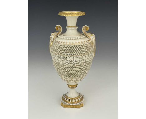 George Owen for Royal Worcester, a reticulated twin handled pedestal vase, 1919, ovoid form, pierced to the body with bands o