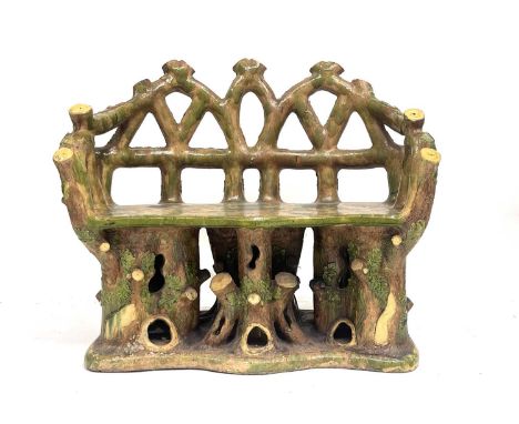 An Art Pottery garden or conservatory double bench, late 19th Century, of naturalistic rustic design with triple Gothic arche