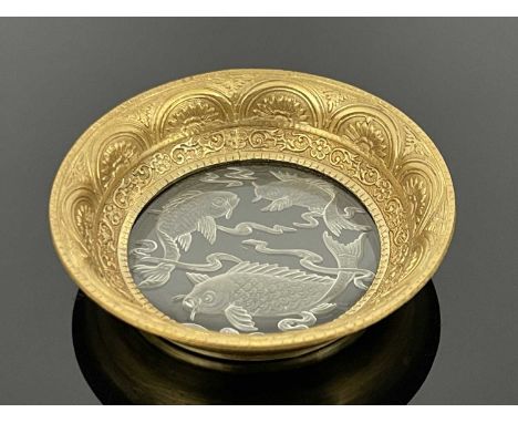 An intaglio engraved Chinese style glass and gilt metal mounted pin dish, the central lens form base reverse decorated with c