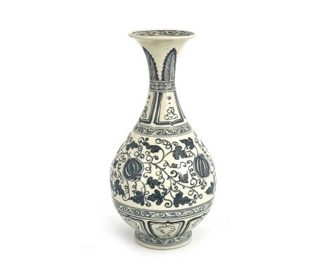 A Chinese blue and white vase, baluster form, painted with pomegranates in foliate scroll ground, between lappet and scroll b
