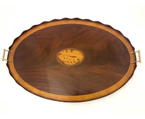 A George III mahogany and boxwood inlaid twin handled tray, oval form, with wave cut gallery enclosing crossbanded border and