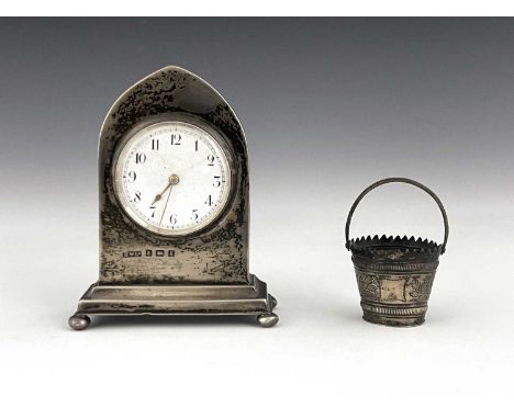 An Edwardian silver desk clock and a novelty silver pin cushion, Horace Woodward, Birmingham 1906, Gothic arch bracket form, 