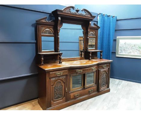 VICTORIAN OAK MIRROR BACK SIDEBOARD, heavily carved with column supports over a base with carved panel doors250cm x 214cmMino